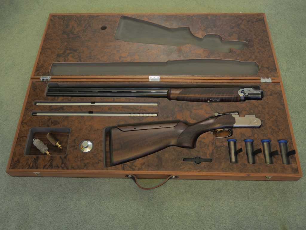American black walnut and burr walnut gun box, detailed ebony stringing. Shot gun and accessory carry case.