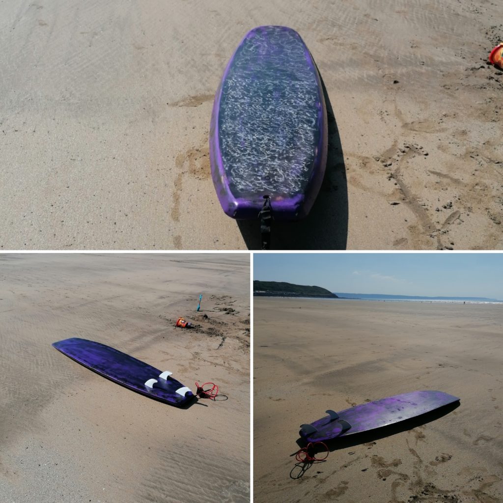 Hollow wooden surfboard day at the beach, waxed up ready to go. A Family fun broad.