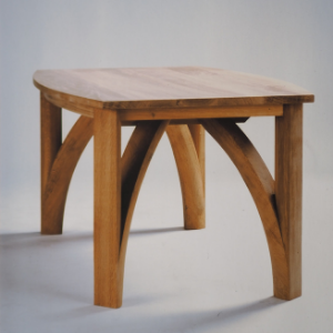 English oak Gothic inspired dining table. hand shaped legs below a convex solid top.