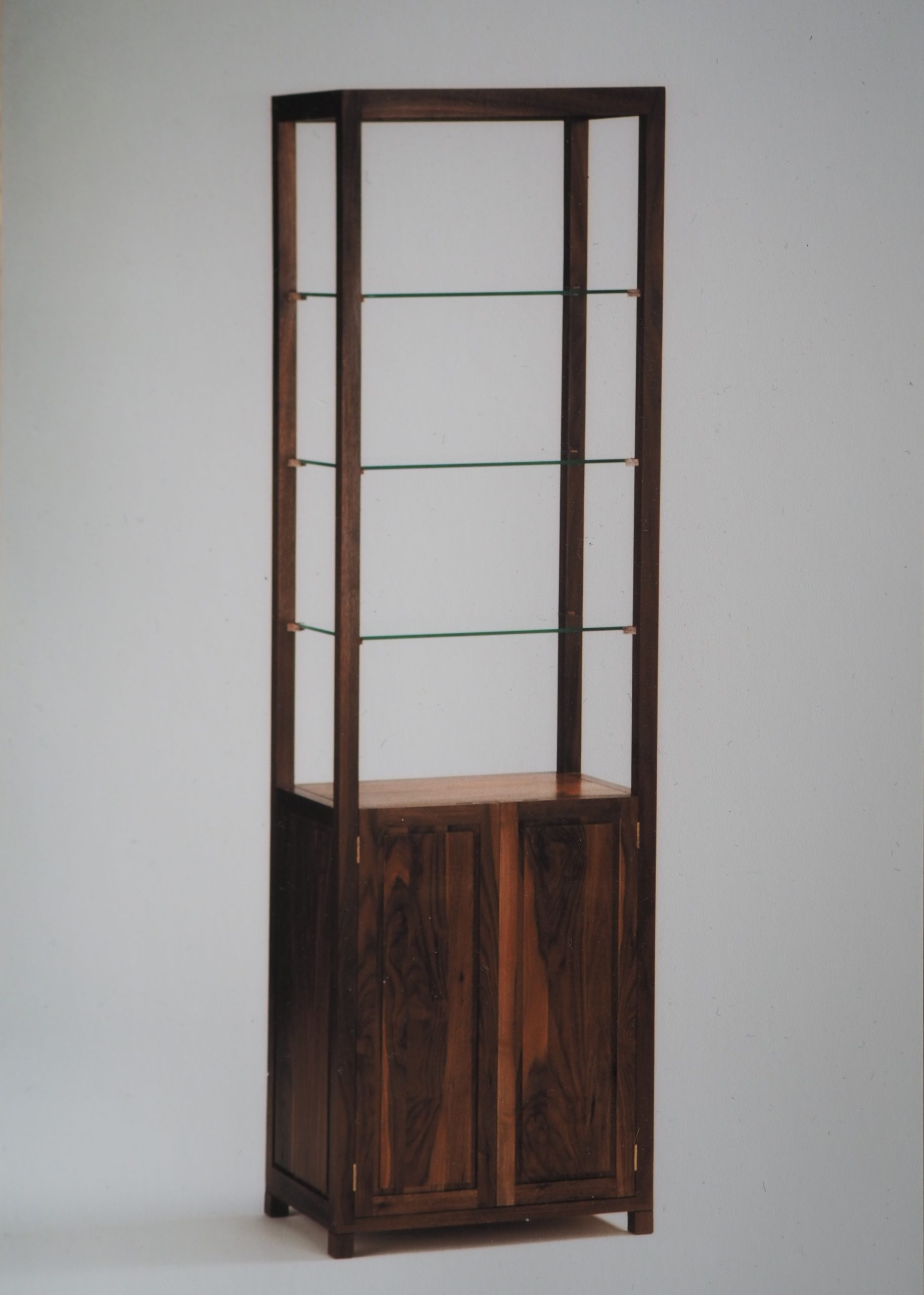Display Cabinet in American Black Walnut with open glass shelving. Storage cupboard underneath shelving. light and airy cabinet to complement and show your displays.
