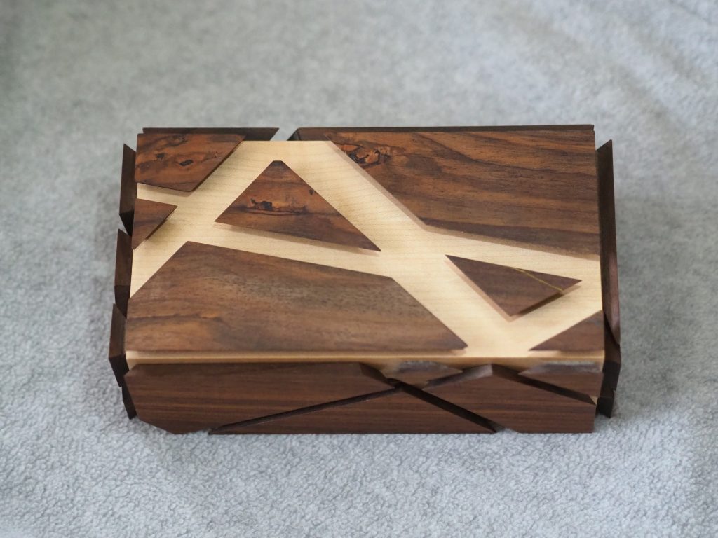 Rosewood and Ripple Sycamore Jewelry Box, angular design with grain running around box as well as pattern, polished chrome but hinges, internal mirror, hidden compartment made by Seaweed UK North Devon cabinet maker, this jewelry box was made by the furniture maker with a secret draw for a engagement ring to be hidden.